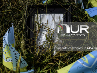 Portraits are fading in the sun at a makeshift memorial in honor of the Ukrainian Armed Forces soldiers who died in battles with Russian tro...