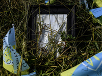 Portraits are fading in the sun at a makeshift memorial in honor of the Ukrainian Armed Forces soldiers who died in battles with Russian tro...