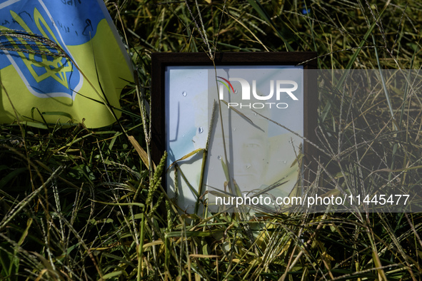 Portraits are fading in the sun at a makeshift memorial in honor of the Ukrainian Armed Forces soldiers who died in battles with Russian tro...