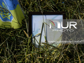 Portraits are fading in the sun at a makeshift memorial in honor of the Ukrainian Armed Forces soldiers who died in battles with Russian tro...