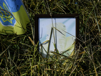 Portraits are fading in the sun at a makeshift memorial in honor of the Ukrainian Armed Forces soldiers who died in battles with Russian tro...