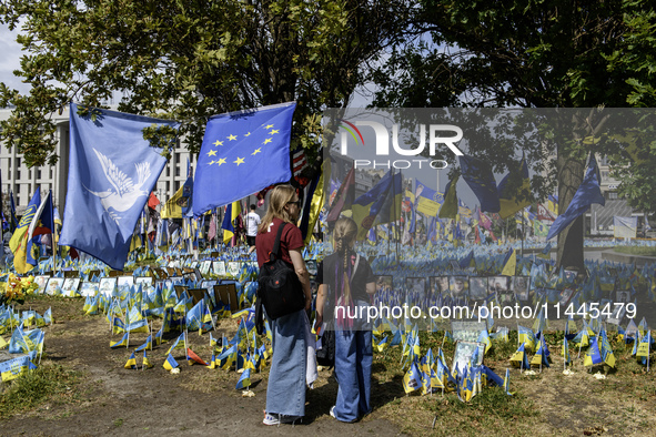 People are visiting a makeshift memorial in honor of the Ukrainian Armed Forces soldiers who died in battles with Russian troops on Independ...