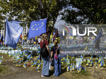 People are visiting a makeshift memorial in honor of the Ukrainian Armed Forces soldiers who died in battles with Russian troops on Independ...