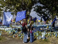 People are visiting a makeshift memorial in honor of the Ukrainian Armed Forces soldiers who died in battles with Russian troops on Independ...