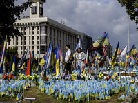 People are visiting a makeshift memorial in honor of the Ukrainian Armed Forces soldiers who died in battles with Russian troops on Independ...