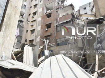 A view is showing a partially destroyed building, which is being targeted by the Israeli army, in Beirut, Lebanon, on July 31, 2024. The Isr...