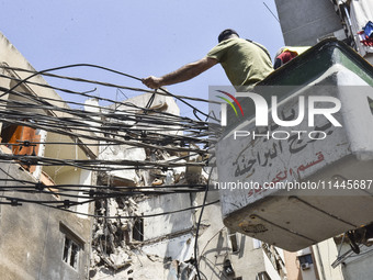 A view is showing a partially destroyed building, which is being targeted by the Israeli army, in Beirut, Lebanon, on July 31, 2024. The Isr...