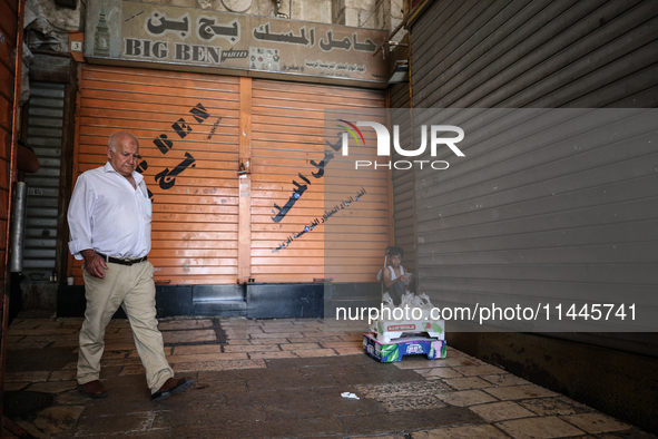 Vendors are closing their shops in the Old City of Jerusalem, Israel, on July 31, 2024, during a general strike following the news of the as...