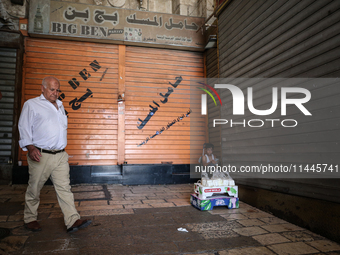 Vendors are closing their shops in the Old City of Jerusalem, Israel, on July 31, 2024, during a general strike following the news of the as...