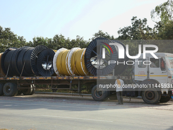 A truck is carrying large spools of pipe in Jaspur, Uttarakhand, India, on April 19, 2024. (