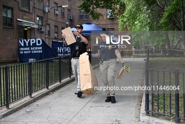 Crime scene investigators from the New York City Police Department are bringing out evidence and evidence markers as they are investigating...