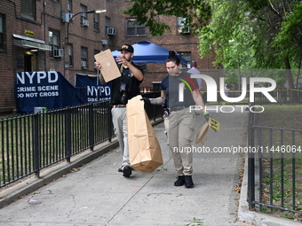 Crime scene investigators from the New York City Police Department are bringing out evidence and evidence markers as they are investigating...