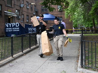 Crime scene investigators from the New York City Police Department are bringing out evidence and evidence markers as they are investigating...