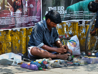 A cobbler is repairing shoes along the footpath in the East Fort area of Thiruvananthapuram (Trivandrum), Kerala, India, on April 13, 2024....