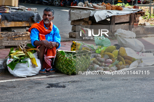 A man is selling fruits along the roadside in Thiruvananthapuram (Trivandrum), Kerala, India, on April 13, 2024. 