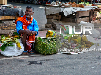 A man is selling fruits along the roadside in Thiruvananthapuram (Trivandrum), Kerala, India, on April 13, 2024. (