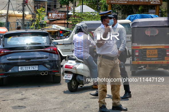 A traffic policeman is directing traffic in Thiruvananthapuram (Trivandrum), Kerala, India, on April 13, 2024. 