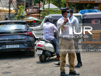 A traffic policeman is directing traffic in Thiruvananthapuram (Trivandrum), Kerala, India, on April 13, 2024. (