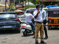 A traffic policeman is directing traffic in Thiruvananthapuram (Trivandrum), Kerala, India, on April 13, 2024. (