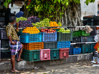 A man is waiting by a fruit stand in the East Fort area of Thiruvananthapuram (Trivandrum), Kerala, India, on April 13, 2024. (