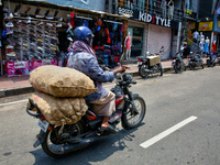 A man is carrying sacks filled with potatoes on his motorbike in Thiruvananthapuram (Trivandrum), Kerala, India, on April 13, 2024. (