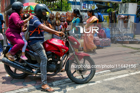 A family is riding a motorbike in Thiruvananthapuram (Trivandrum), Kerala, India, on April 13, 2024. 