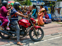 A family is riding a motorbike in Thiruvananthapuram (Trivandrum), Kerala, India, on April 13, 2024. (