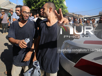 Men who are being detained by Israel during the military operation in Gaza are reacting after their release at the Aqsa Martyrs Hospital in...