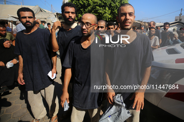 Men who are being detained by Israel during the military operation in Gaza are reacting after their release at the Aqsa Martyrs Hospital in...