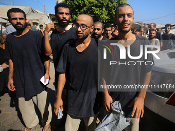 Men who are being detained by Israel during the military operation in Gaza are reacting after their release at the Aqsa Martyrs Hospital in...