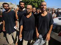 Men who are being detained by Israel during the military operation in Gaza are reacting after their release at the Aqsa Martyrs Hospital in...