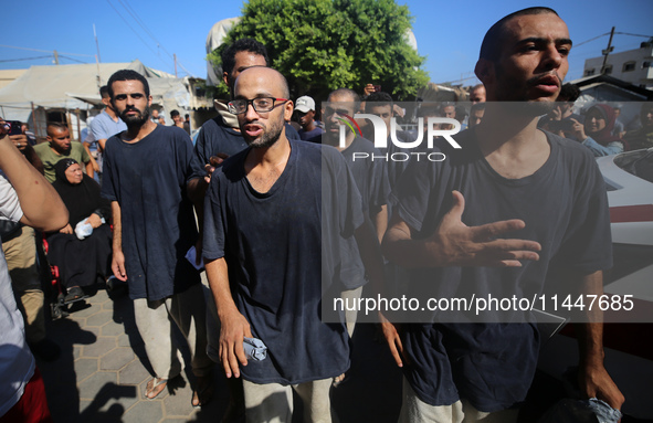 Men who are being detained by Israel during the military operation in Gaza are reacting after their release at the Aqsa Martyrs Hospital in...