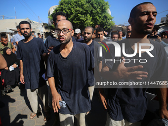 Men who are being detained by Israel during the military operation in Gaza are reacting after their release at the Aqsa Martyrs Hospital in...