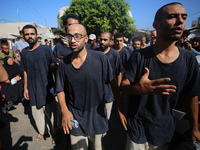 Men who are being detained by Israel during the military operation in Gaza are reacting after their release at the Aqsa Martyrs Hospital in...