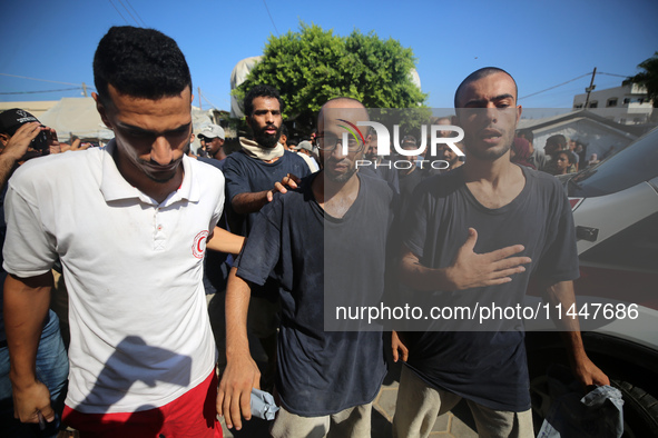 Men who are being detained by Israel during the military operation in Gaza are reacting after their release at the Aqsa Martyrs Hospital in...