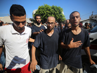 Men who are being detained by Israel during the military operation in Gaza are reacting after their release at the Aqsa Martyrs Hospital in...