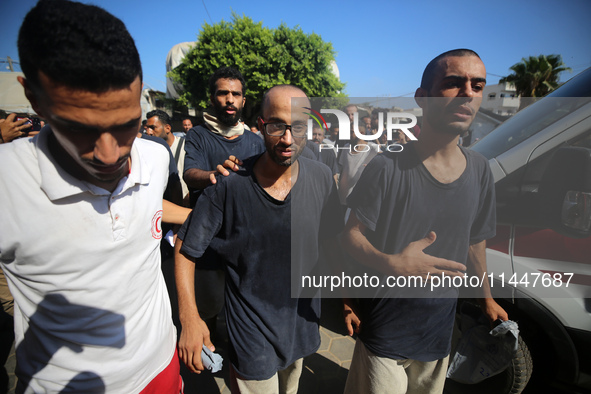 Men who are being detained by Israel during the military operation in Gaza are reacting after their release at the Aqsa Martyrs Hospital in...