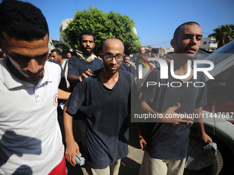 Men who are being detained by Israel during the military operation in Gaza are reacting after their release at the Aqsa Martyrs Hospital in...