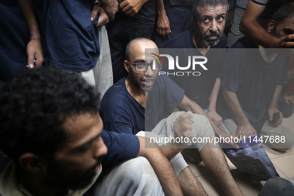 Men who are being detained by Israel during the military operation in Gaza are reacting after their release at the Aqsa Martyrs Hospital in...