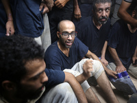 Men who are being detained by Israel during the military operation in Gaza are reacting after their release at the Aqsa Martyrs Hospital in...