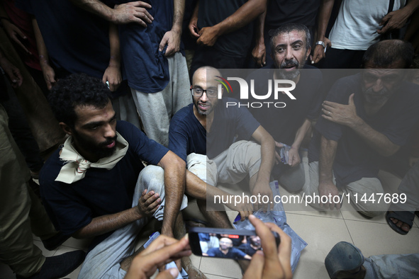 Men who are being detained by Israel during the military operation in Gaza are reacting after their release at the Aqsa Martyrs Hospital in...