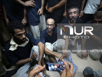 Men who are being detained by Israel during the military operation in Gaza are reacting after their release at the Aqsa Martyrs Hospital in...