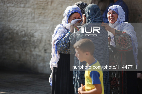 Palestinians are mourning over the bodies of loved ones  following Israeli bombardment in Deir el-Balah in the central Gaza Strip on August...