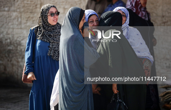 Palestinians are mourning over the bodies of loved ones  following Israeli bombardment in Deir el-Balah in the central Gaza Strip on August...