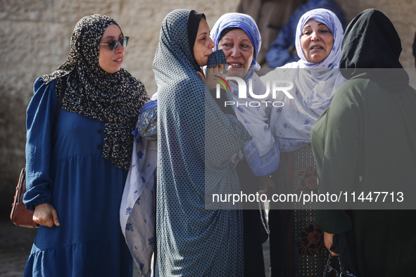 Palestinians are mourning over the bodies of loved ones  following Israeli bombardment in Deir el-Balah in the central Gaza Strip on August...