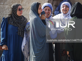 Palestinians are mourning over the bodies of loved ones  following Israeli bombardment in Deir el-Balah in the central Gaza Strip on August...