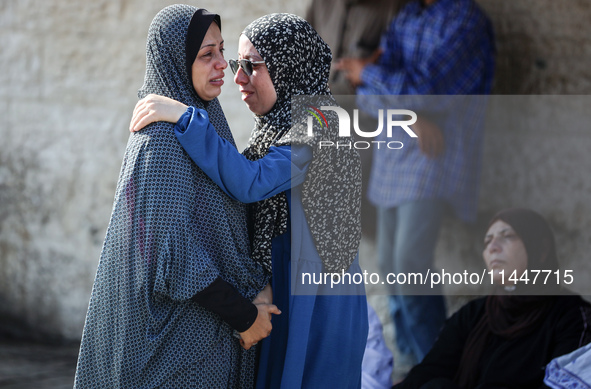 Palestinians are mourning over the bodies of loved ones  following Israeli bombardment in Deir el-Balah in the central Gaza Strip on August...