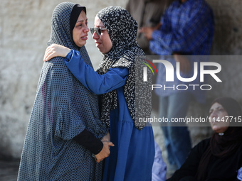 Palestinians are mourning over the bodies of loved ones  following Israeli bombardment in Deir el-Balah in the central Gaza Strip on August...