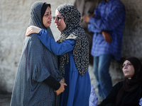 Palestinians are mourning over the bodies of loved ones  following Israeli bombardment in Deir el-Balah in the central Gaza Strip on August...