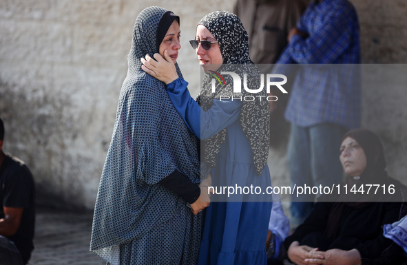 Palestinians are mourning over the bodies of loved ones  following Israeli bombardment in Deir el-Balah in the central Gaza Strip on August...